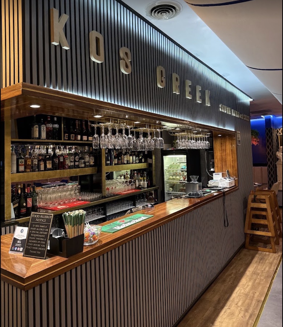 The polished wood bar at KOS